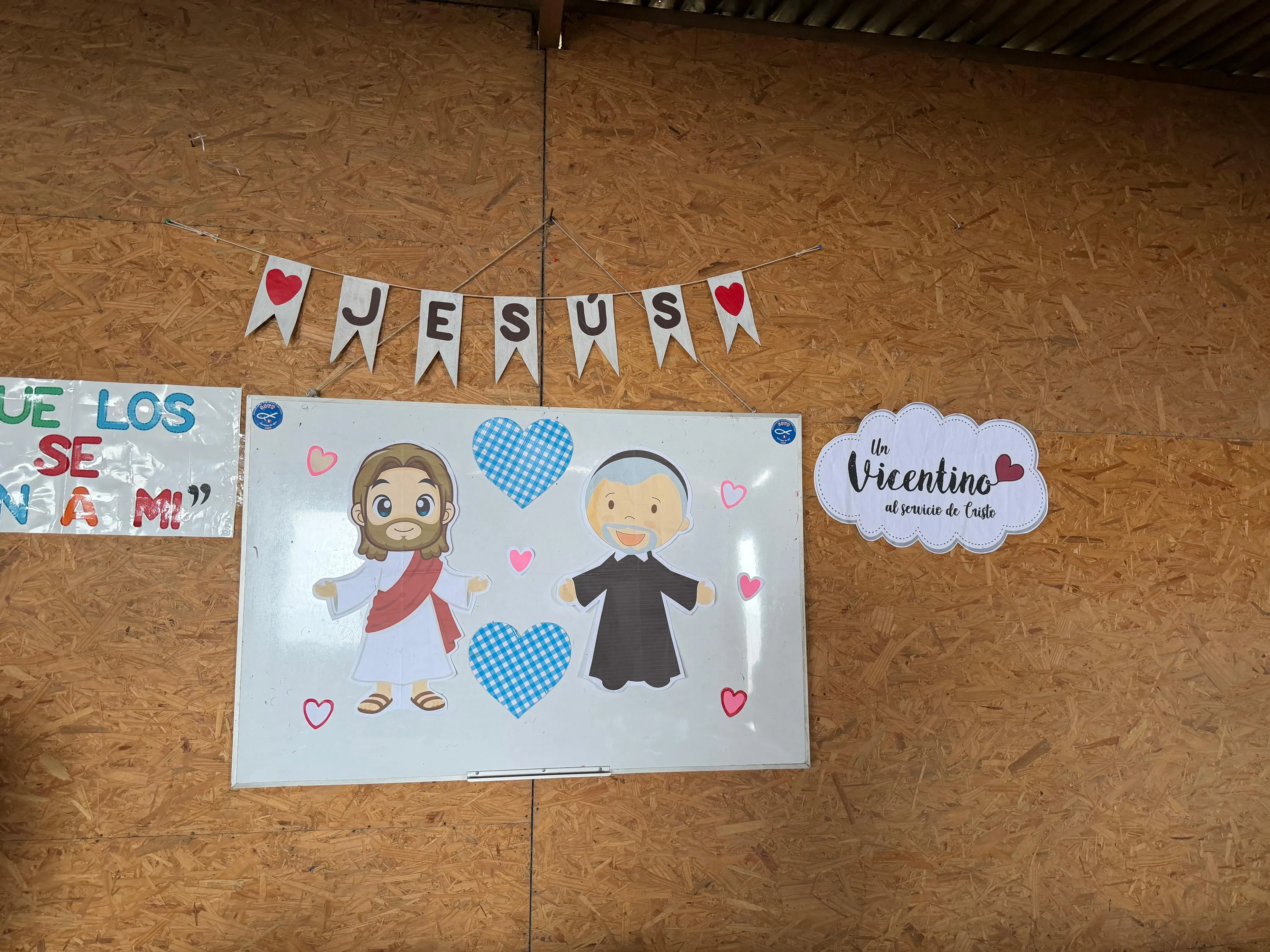 Decoración del local con el cartel "Jesús" y la imagen de un vicentino al servicio de Cristo